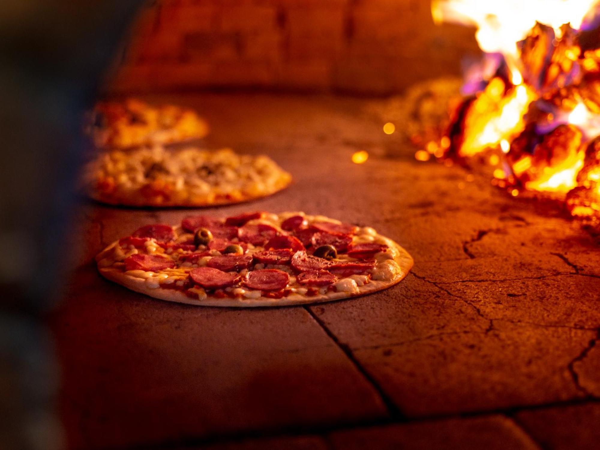 Ocean Palace All Inclusive Premium Natal Eksteriør bilde Pizza being cooked in a wood-fired oven